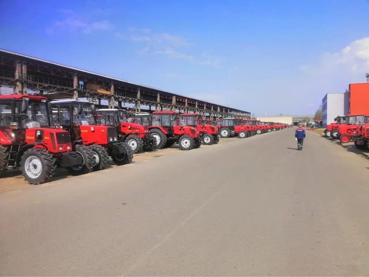 Rows of new red Belarus MTZ tractors at the factory yard